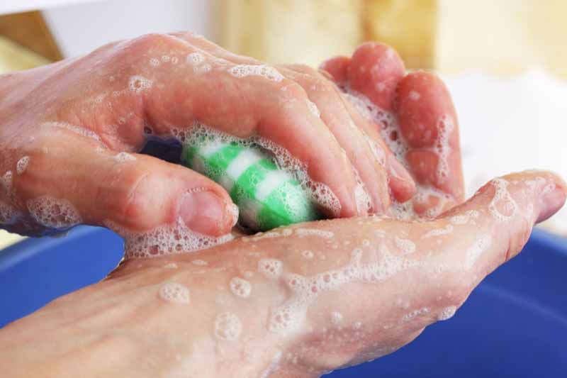 Man washing hands with soap bar